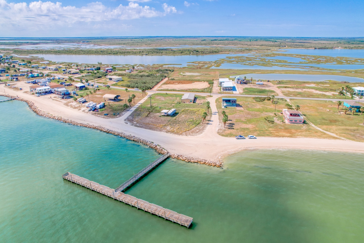Aerial view of coastal village and pier.